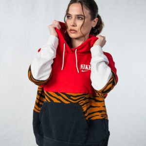 Female model holding collar of Nike sweatshirt