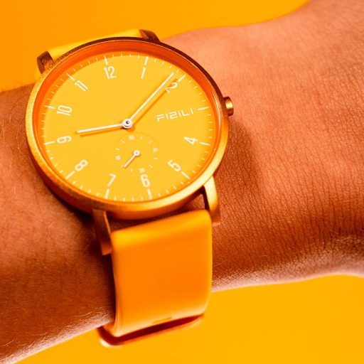 Model wearing yellow watch as part of electronics product photography shoot with Product Pop