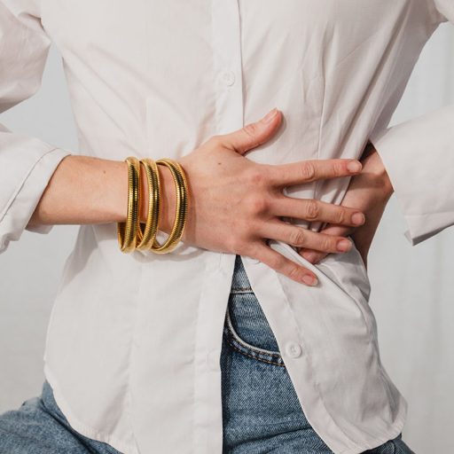 Model wearing gold bracelets as part of Jewelry Product Photography shoot with Product Pop